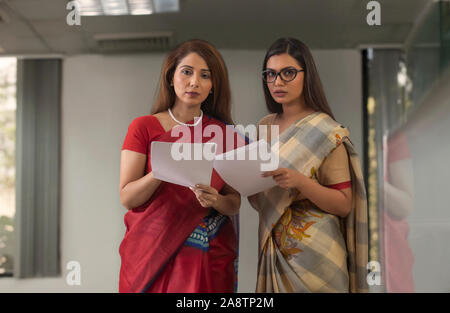 two employees analysing reports Stock Photo