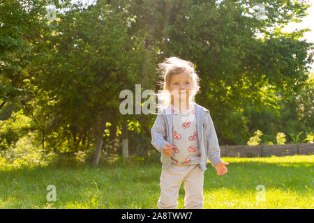 Adorable little girl having fun in sunny day Stock Photo