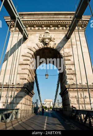 Architectural detail of lion carving and coats of arms above arch on Budapest Chain Bridge Stock Photo