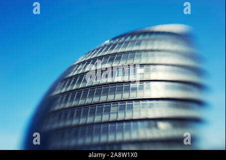 LONDON - JUNE 14, 2012: Tilt shift view of City Hall, the ovoid building designed by architect Sir Norman Foster, standing in blue sky. Stock Photo