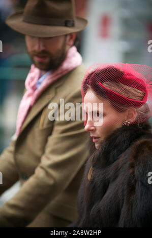 LONDON - MAY 6, 2012: A British couple in retro fashion take part in the Tweed Run, an event featuring cyclists in traditional cycling attire. Stock Photo