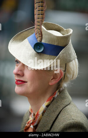 LONDON - MAY 6, 2012: Woman in herringbone jacket and old-fashioned hat takes part in the Tweed Run, an featuring cyclists in traditional attire. Stock Photo
