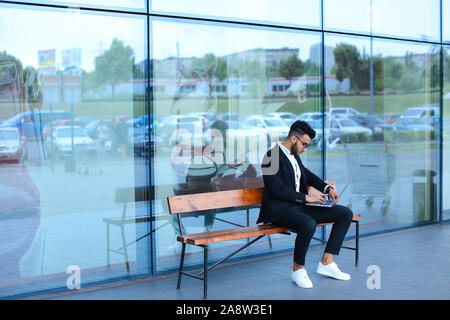 Cool guy arabic man uses laptop business center Stock Photo