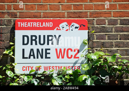 LONDON - MAY 25, 2012: Sign for Drury Lane features a Theatreland designation with theatrical masks in summer sunlight.