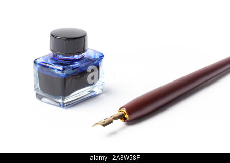 Old calligraphy fountain ink pen and bottle with ink isolated on white. Stock Photo