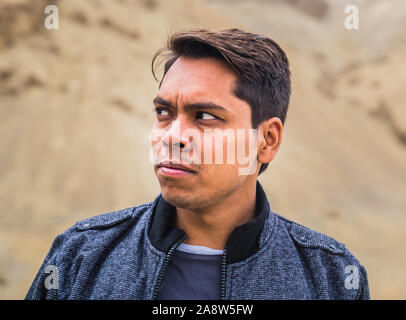Close up of Indian man thinking against scenic view of leh and ladakh region, India. Stock Photo