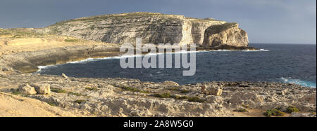 Scenic view of cliffs, fungus rock and blue ocean at dweira bay in gozo, malta.