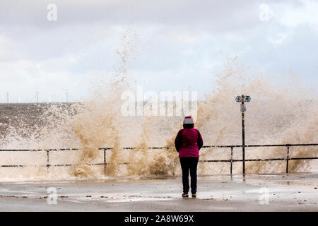 Colwyn Bay, North Wales, UK. 11th November 2019.UK Weather Wet and windy at for many today with dangerous conditions on coastal areas with high tides causing huge waves as seen at Colwyn Bay in North Wales as this wave watcher discovered Credit: DGDImages/Ģ����ý Live News Stock Photo