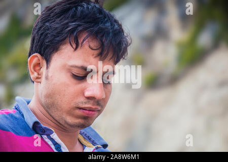 Indian Man thinking moody portrait. Shallow depth of filed Stock Photo