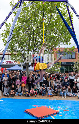 Melbourne, Australia - October 20, 2019: Aerial contortion acrobat performing in front of large crowd on the street Stock Photo