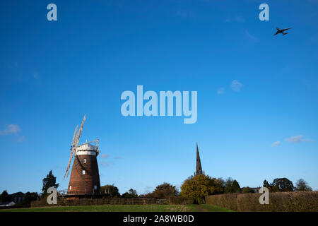 Thaxted Essex England. John Webb's windmill built in 1804.Nov 2019 Jet Plane landing as Stansted Airport, Wikipeadia John Webb's Mill or Lowe's Mill w Stock Photo