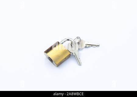 keys lies next to a padlock isolate on a white background Stock Photo