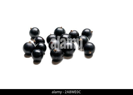 Blackcurrant isolated on a white background. Currant macro photo. Heap of black currant berry. Stock Photo