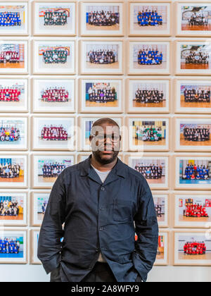 London, UK. 11th Nov, 2019. Steve McQueen's (pictured) Year 3 project can now be seen as a large-scale installation at in the Duveen Galleries at Tate Britainon. It is also ovn 600 billboards across all 33 of London's boroughs. The images feature class photos of Year 3 school children from London primary schools. The billboards are on high streets, railway platforms, roadside sites, and underground stations until mid-November and the images are on show at the Tate from 12 November 2019 - 3 May 2020. The project is a partnership between Tate, Artangel and A New Direction. Credit: Guy Bell/Alamy Stock Photo