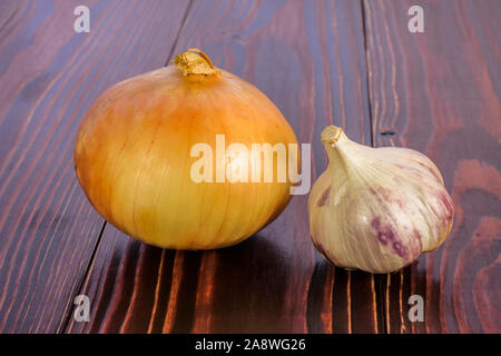Bulb and garlic head on a wooden table Stock Photo