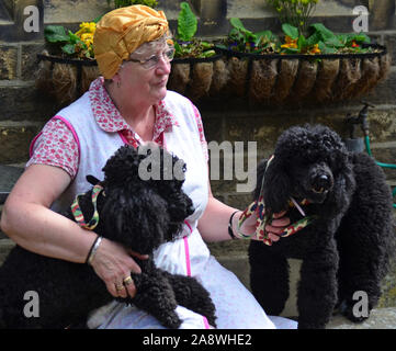 Woman in 1940s clothes with two poodles, Haworth 1940s weekend Stock Photo