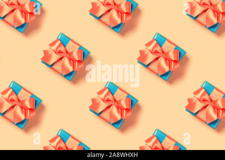 Pattern with stylish gift on a trendy coral background. Present for St. Valentine's day, engagements, Mother's Day, birthday, New Year, Christmas, holidays Stock Photo