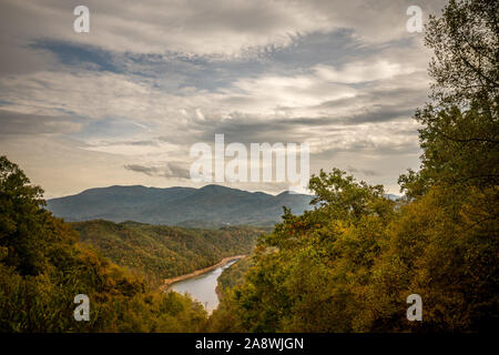 View of lake and mountains with cloudy sky. Stock Photo