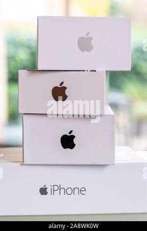 Close up of a pile of a collection of Apple iPhone boxes generations, white boxes with Apple logo Stock Photo