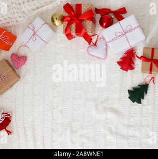 Christmas gift boxes on woolen duvet with decorations Stock Photo