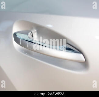 Modern door handle in a car with a button. Keyless Entry System, close-up Stock Photo