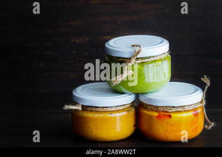 Several types of typical Canary Islands sauces in glass jar: Mojo picon, mojo verde  made and almogrote are popular souvenirs of the fun holiday exper Stock Photo