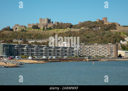 General view of Dover beach harbour, apartment blocks on the beach and Dover Castle. Stock Photo