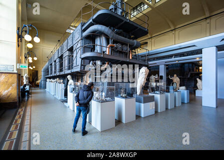 Rome. Italy. Centrale Montemartini Museum, ancient roman sculptures displayed amongst the industrial machinery of the old electrical power plant. Stock Photo