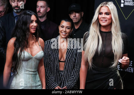 Sisters Kim Kardashian West, Kourtney Kardashian and Khloe Kardashian arrive at the 2019 E! People's Choice Awards held at Barker Hangar on November 10, 2019 in Santa Monica, Los Angeles, California, USA. (Photo by Xavier Collin/Image Press Agency) Stock Photo