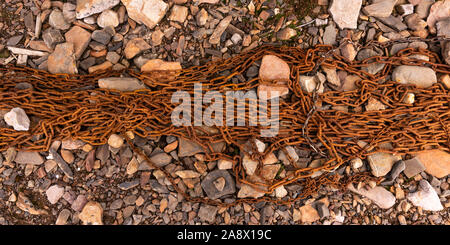 Old rusty chain on a rocky beach in Svalbard. Stock Photo