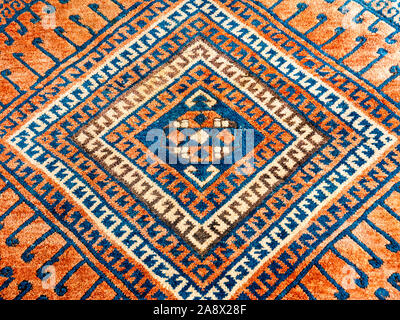 Square geometric pattern, detail of oriental persian carpet in mainly red and blue Stock Photo