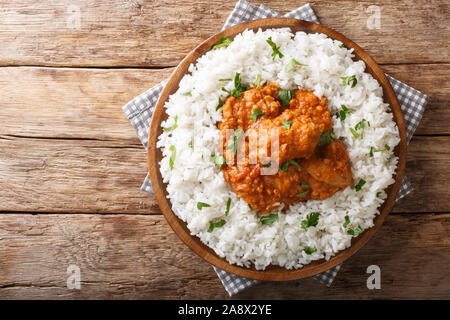 Rustic style Chicken dhansak is a lentil curry with spices served with rice closeup in a plate on a table. Horizontal top view from above Stock Photo