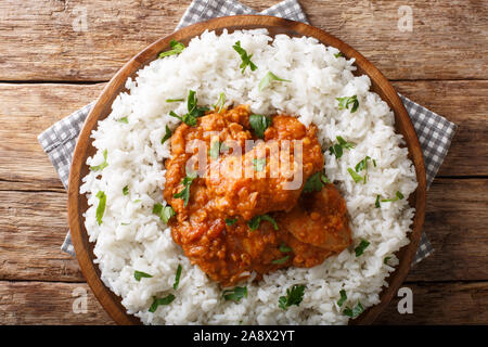 chicken dhansak is a delicious home made lentil curry infused with spices with rice garnish closeup on a plate on the table. Horizontal top view from Stock Photo
