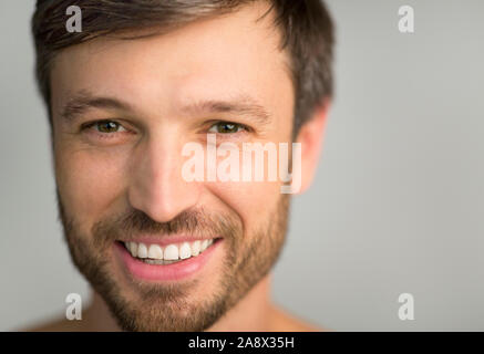 Man Looking At Camera Smiling Posing Over Gray Background Stock Photo