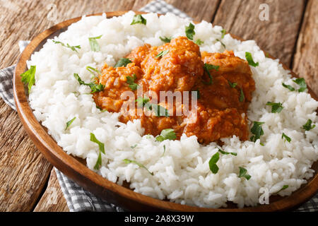 chicken dhansak is a delicious home made lentil curry infused with spices with rice garnish closeup on a plate on the table. horizontal Stock Photo