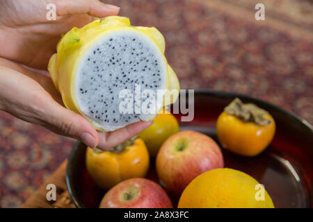 Close up view of a sliced yellow Dragon fruit (Pitaya), in a fruit bowl Stock Photo