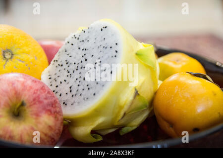 Close up view of a sliced yellow Dragon fruit (Pitaya), in a fruit bowl Stock Photo