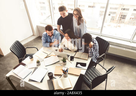 Group of students working together on school assignment Stock Photo