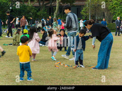 Shanghai, China, young Chinese families in the park, People Enjoying Urban Park, Fuxing Park, City Center, groups of people in park, busy china, toddlers playing together Stock Photo