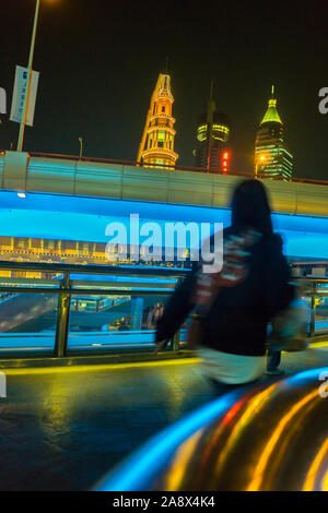 Shanghai, China, Street Scene Woman from behind, blur, on Escalator at Night with Lights, busy Stock Photo