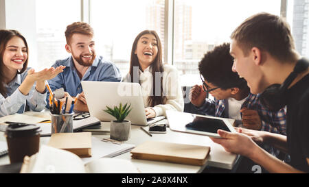 University friends enjoying group study in library Stock Photo