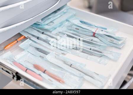 Close up of dentist tools in open drawer Stock Photo