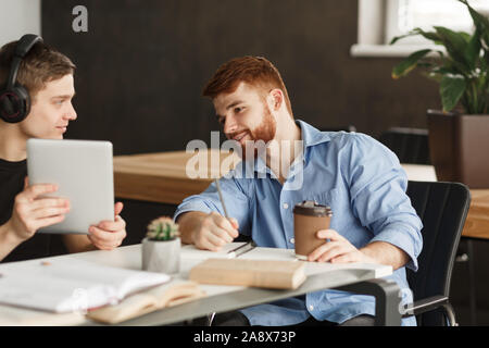 Smart student helping his classmate with homework Stock Photo