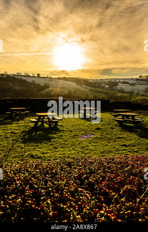Sunset over some picnic tables in the glorious Derbyshire peak district national park, Empty tables on a frosty cold January evening at sunset Stock Photo