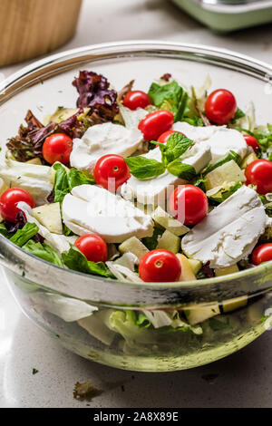 Goat Cheese Salad with Roasted Walnuts,  Cherry Tomatoes and Diced Apple Cubes. Organic Fresh Food. Stock Photo