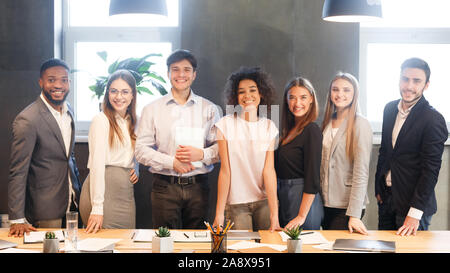 Young business team smiling to camera, having break Stock Photo