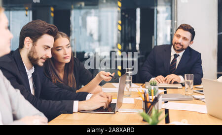 Young business team discussing new ideas in office Stock Photo