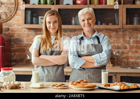 Adult mother and daughter baking together at home Stock Photo