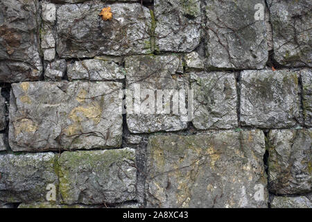 Texture of old big stone wall. Backdrop of medieval historic building. Large dirty rocks texture close up Stock Photo