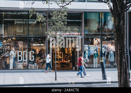 London, UK - July 18, 2019: People walking in front of Urban Outfitters shop in London, selective focus. Urban Outfitters is an international lifestyl Stock Photo